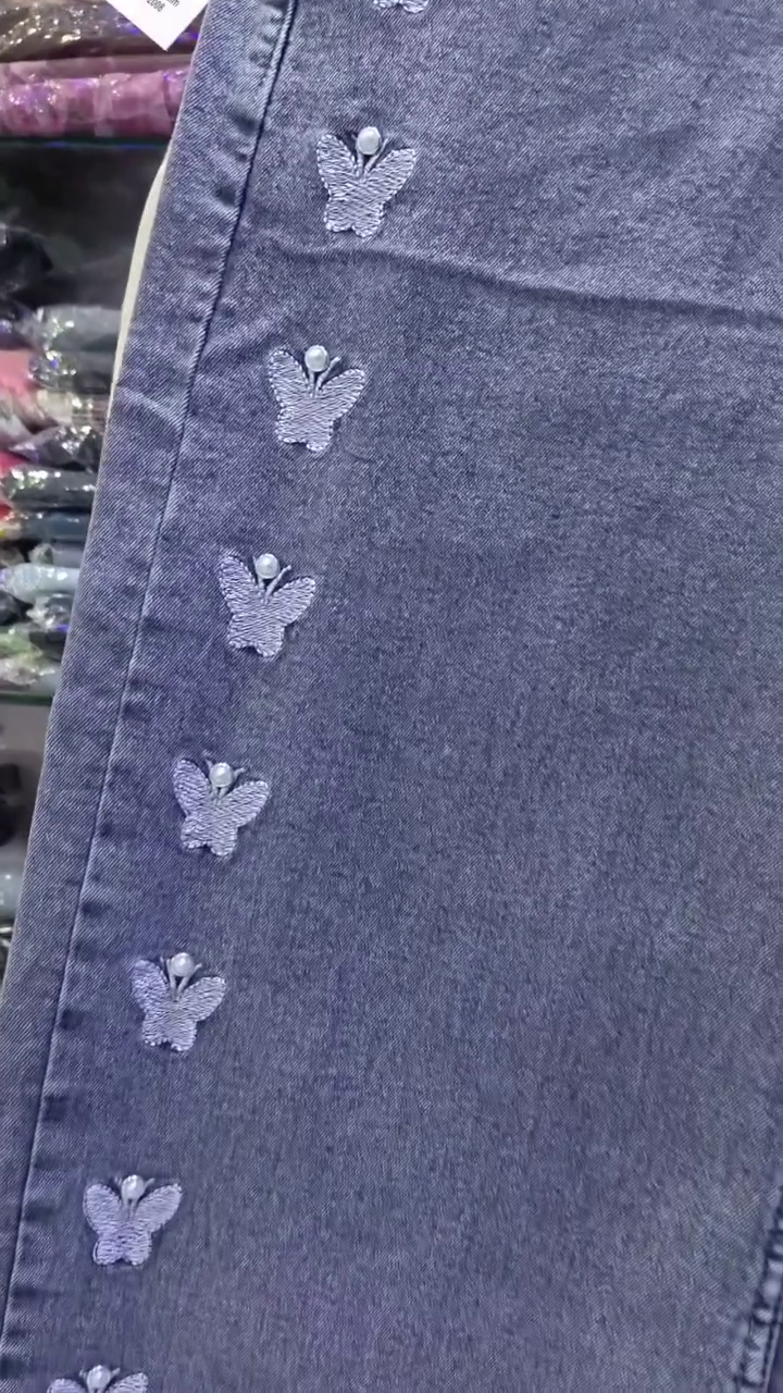 Light Blue Denim Jeans 💙👖 with Vertical White Butterfly Designs 🦋✨ Five-Pocket Style 📦 and Button Closure ⚪