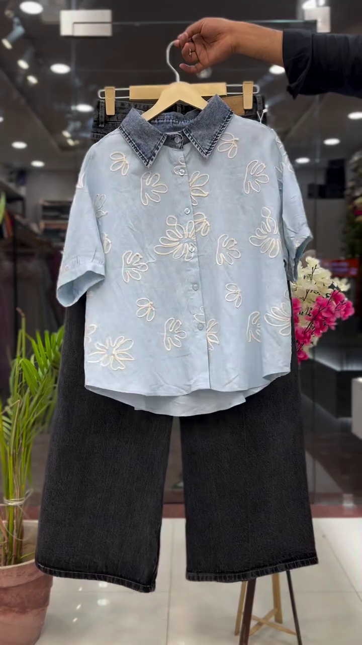 Light Blue Short-Sleeve Button-Down Shirt with White Abstract Floral Outline Embroidery and Contrast Denim Collar Paired with Charcoal Wide-Leg Jeans